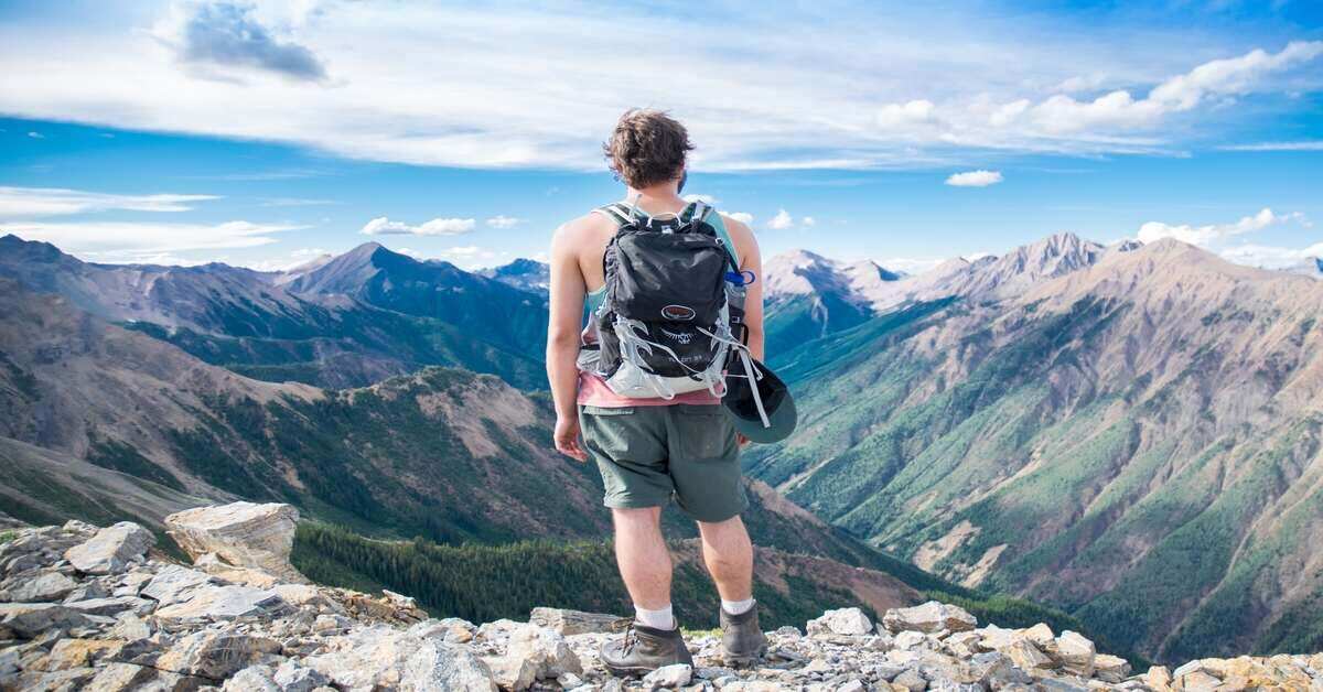 hiker atop a mountain