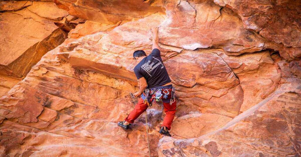 climber scaling a rock