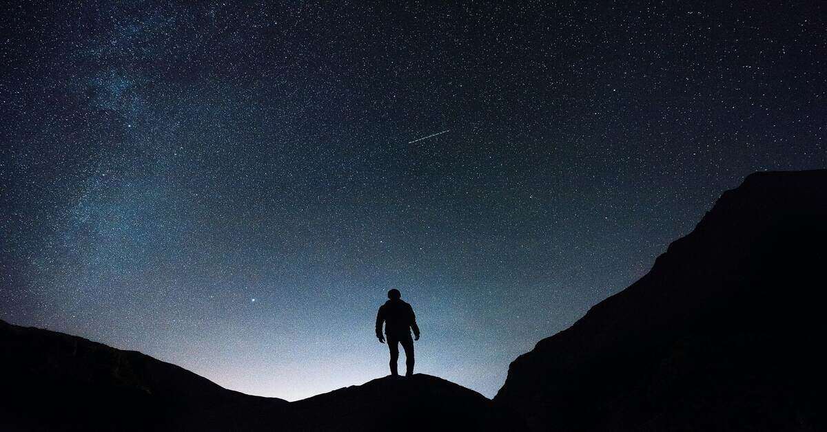 hiker standing at a mountain top