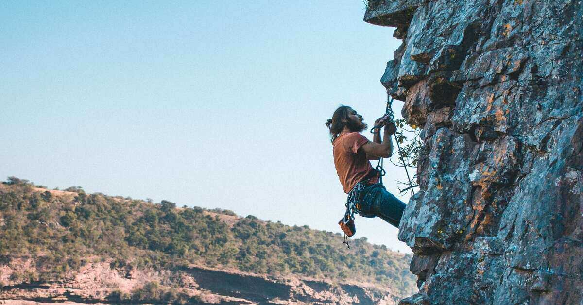 man climbing a rock