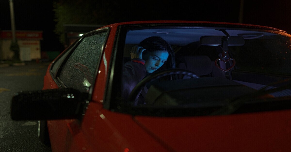 woman staying warm in a car overnight