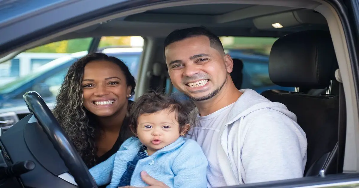 couple with toddler in car