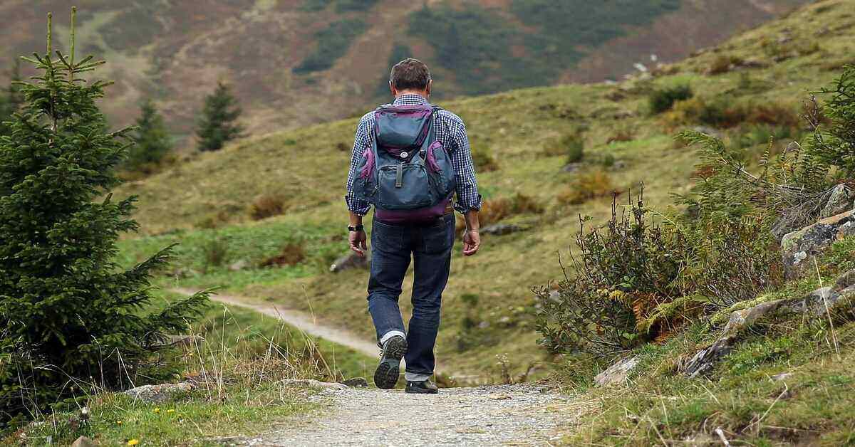 man walking ahead on a trail