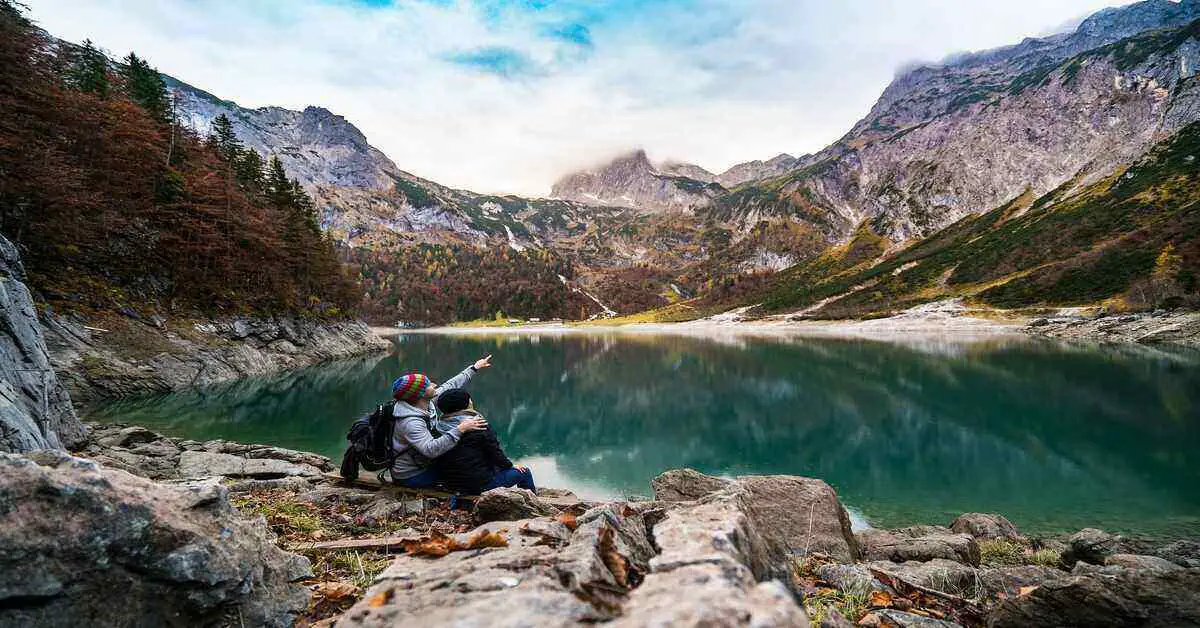 hiking couple seated near lake
