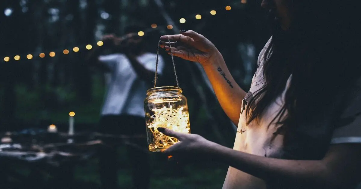 camper holding a glow jar