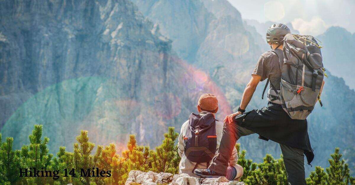 photo of two hikers looking at a mountain range
