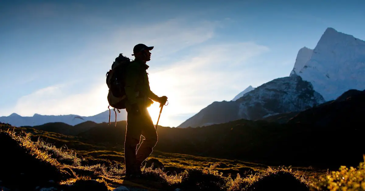 photo of hiker with sunrise in the background