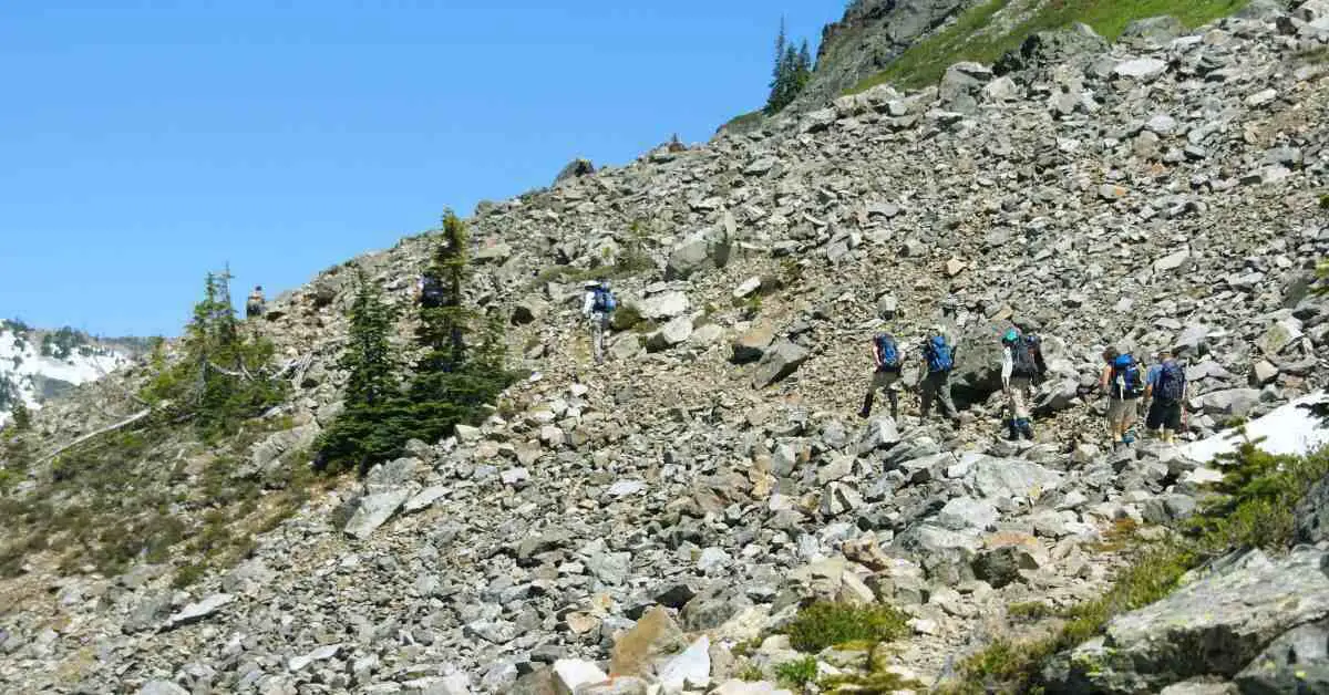 photo of hikers on a rocky trail